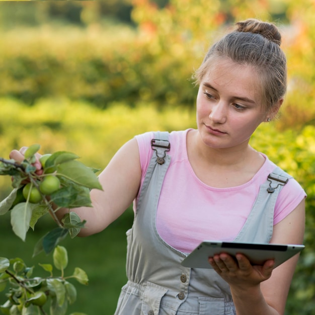 Medium shot girl holding tablet