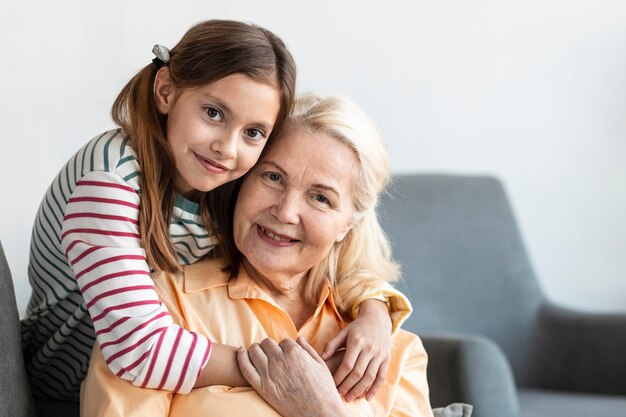 Medium shot girl hugging woman