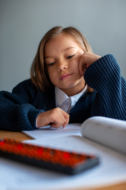 Medium shot girl learning math at school