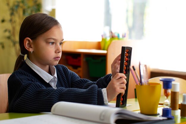 Medium shot girl learning math at school