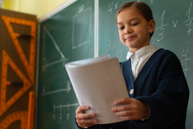 Medium shot girl learning math at school