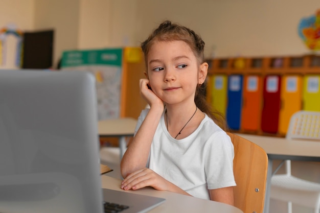 Medium shot girl learning at school