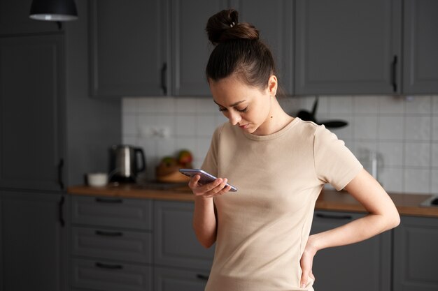 Medium shot girl looking at smartphone