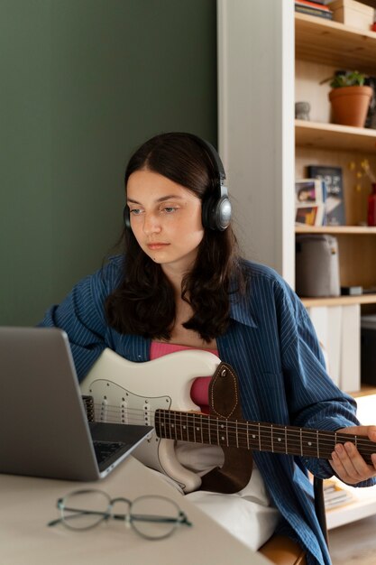 Medium shot girl making music indoors