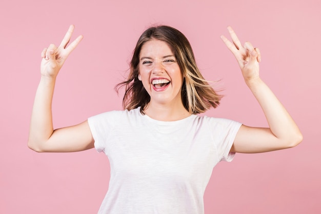 Medium shot girl making peace sign