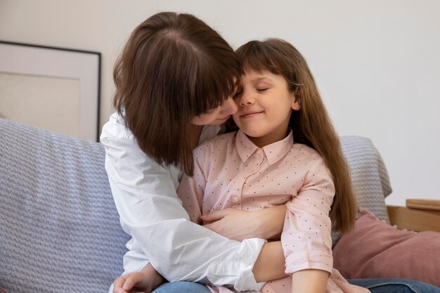 Medium shot girl and mother on couch