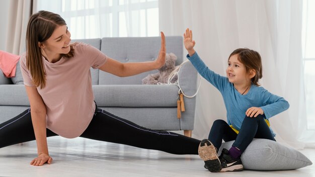 Medium shot girl and mother training