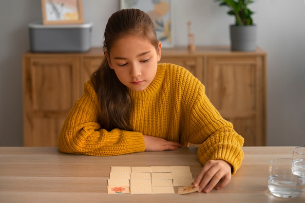 Medium shot girl playing memory game