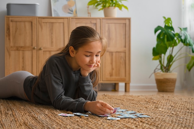 Medium shot girl playing memory game