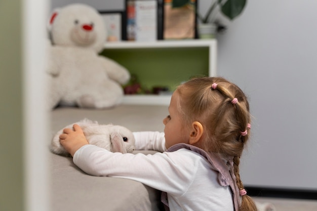 Medium shot girl playing with bunny