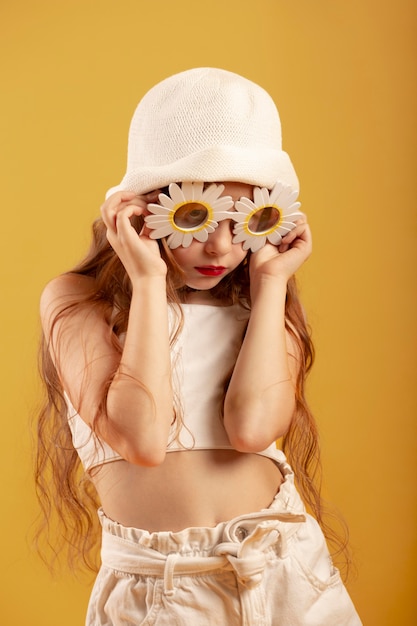 Medium shot girl posing with hat