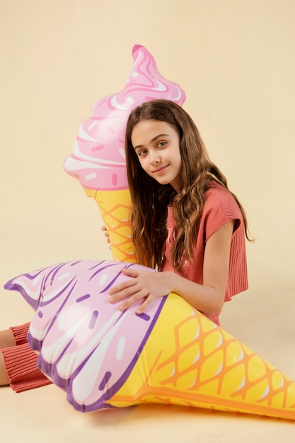 Free Photo medium shot girl posing with ice cream toys