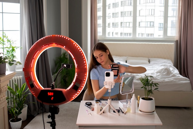 Medium shot girl recording her makeup routine