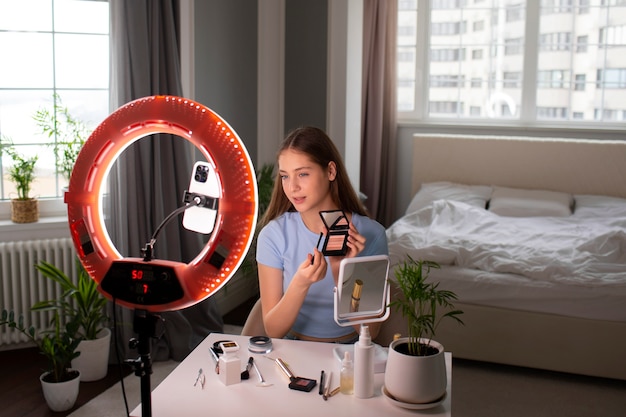 Medium shot girl recording her makeup routine