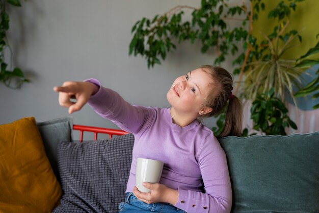 Medium shot girl sitting on couch