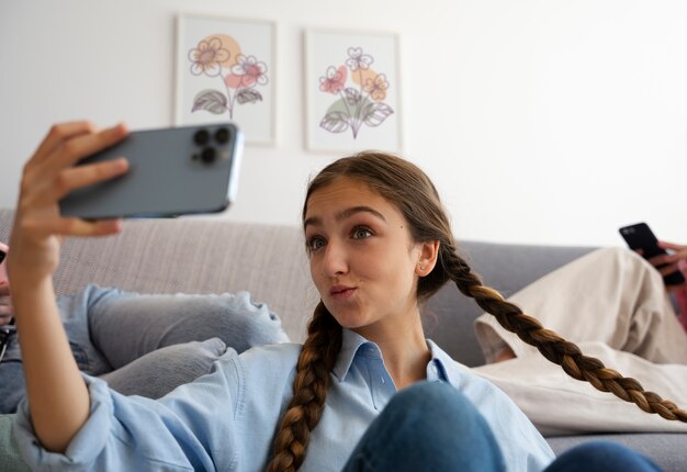 Medium shot girl taking selfie