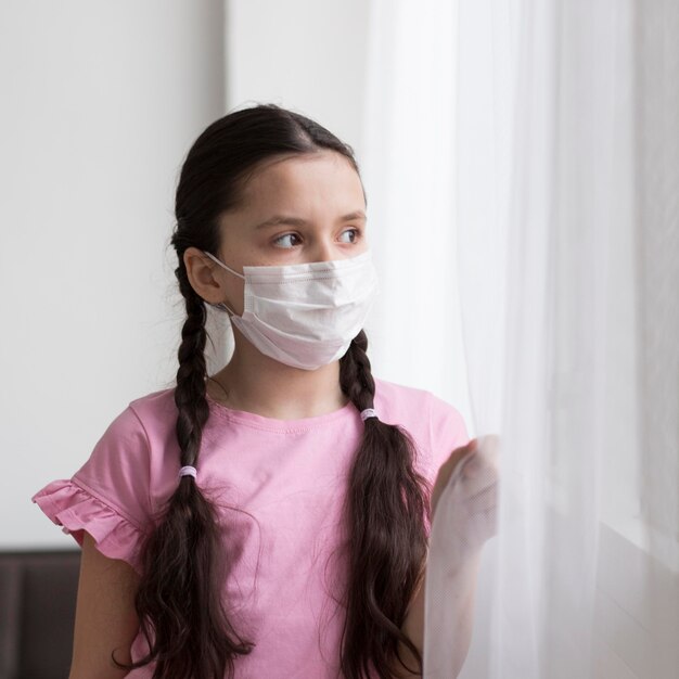 Medium shot girl wearing mask