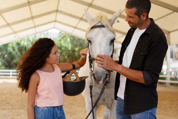 Free photo medium shot girl with beautiful horse