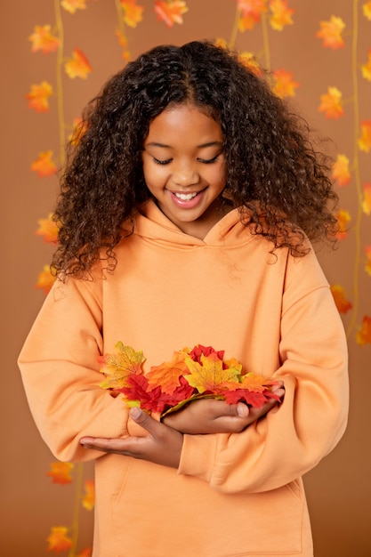 Medium shot girl with colorful leaves