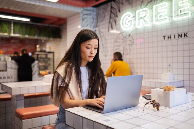 Medium shot girl with laptop