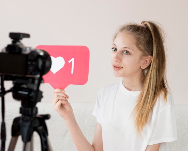 Medium shot girl with video camera