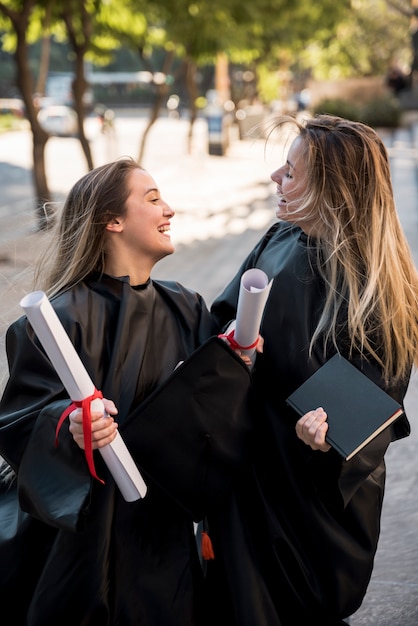 Medium shot girls being cheerful at their graduation