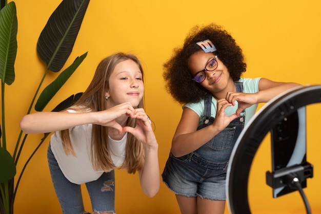 Medium shot girls recording with ring light