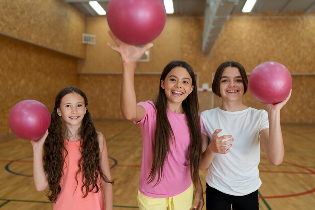 Medium shot girls throwing balls