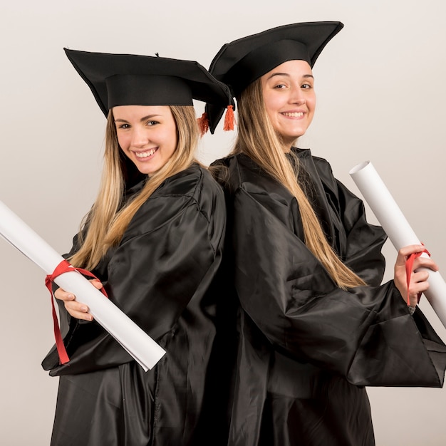 Free photo medium shot graduate posing and smiling at the camera