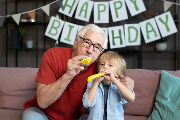 Free photo medium shot grandfather and boy at party