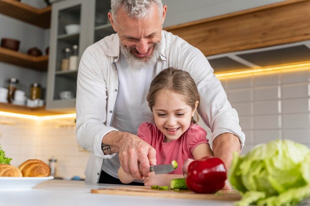 Medium shot grandfather and girl in kitchen