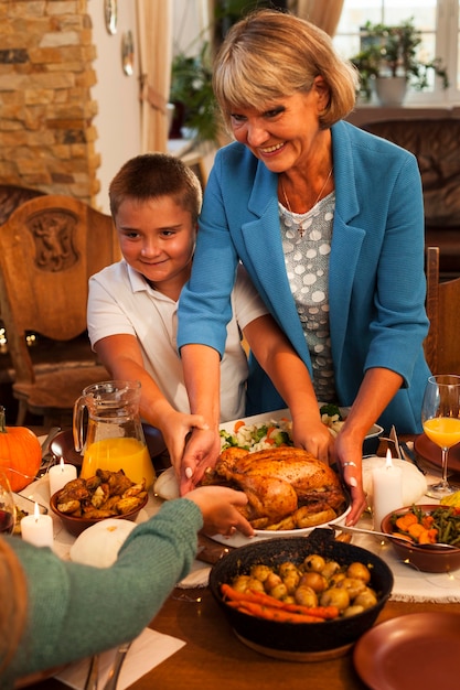 Medium shot grandma and kid at dinner