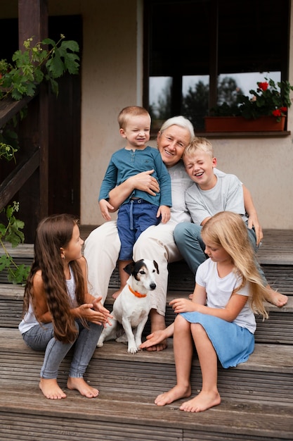 Medium shot grandmother and kids on stairs