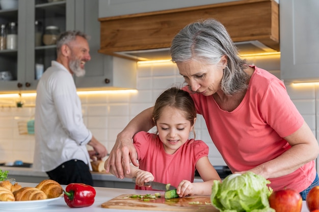 Medium shot grandparents and girl in kitchen