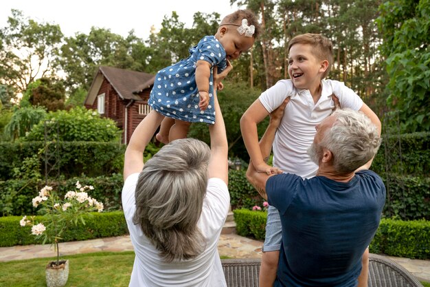 Medium shot grandparents holding kids