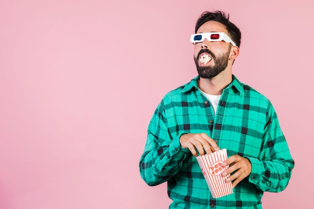 Medium shot guy with mouth full of popcorn