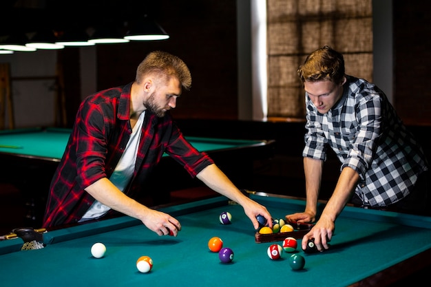 Free photo medium shot guys arranging pool balls