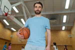 Free photo medium shot gym teacher holding basket ball