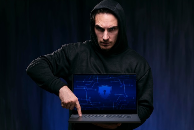 Medium shot hacker holding laptop