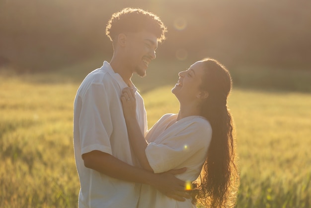 Medium shot happy couple hugging outdoors