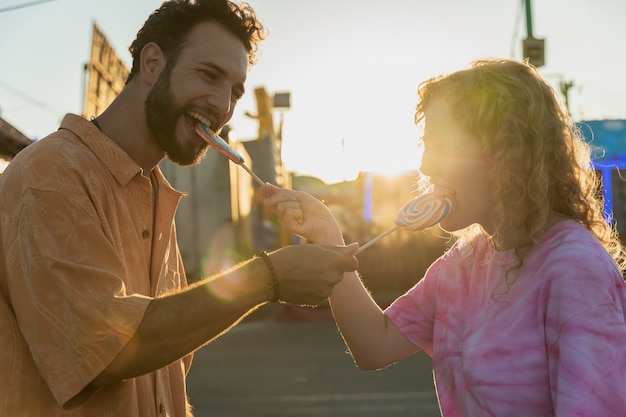 Medium shot happy couple and lollipops