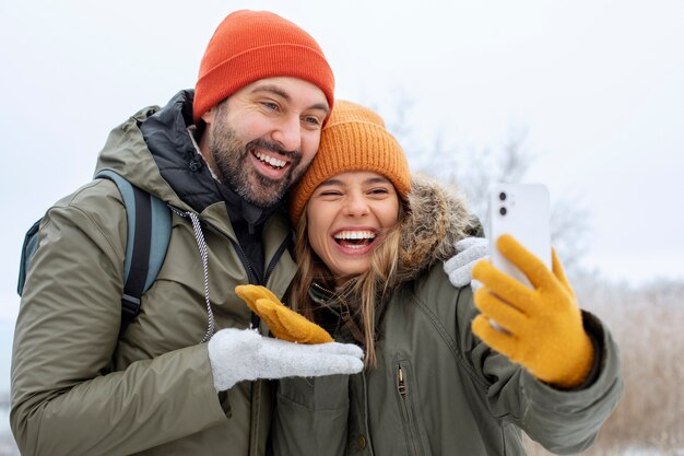 Medium shot happy couple taking selfie