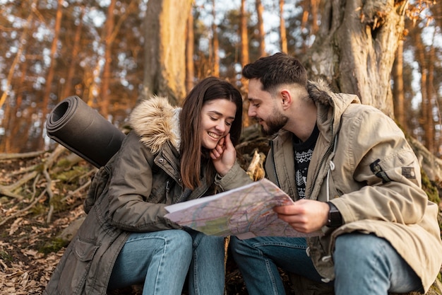 Free photo medium shot happy couple with map