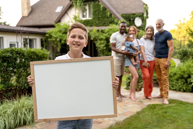 Free photo medium shot happy family and board