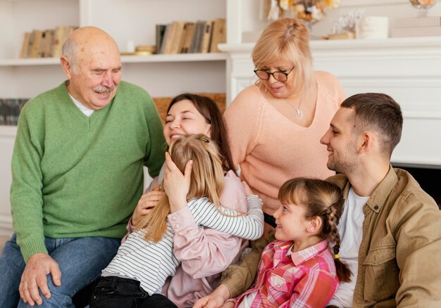 Medium shot happy family on couch