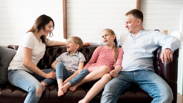 Free Photo medium shot happy family in living room