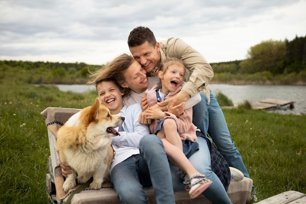 Medium shot happy family in nature