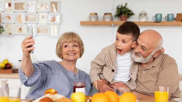 Medium shot happy family taking selfie