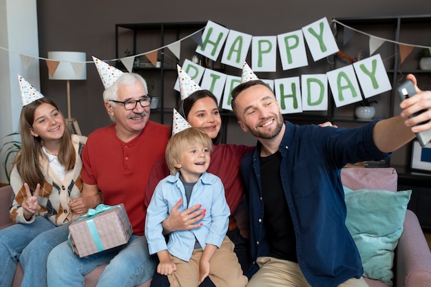 Free photo medium shot happy family taking selfie