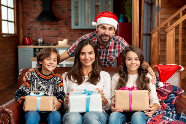 Medium shot happy family with gifts